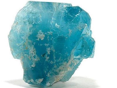 A blue topaz gemstone in unpolished crystal form